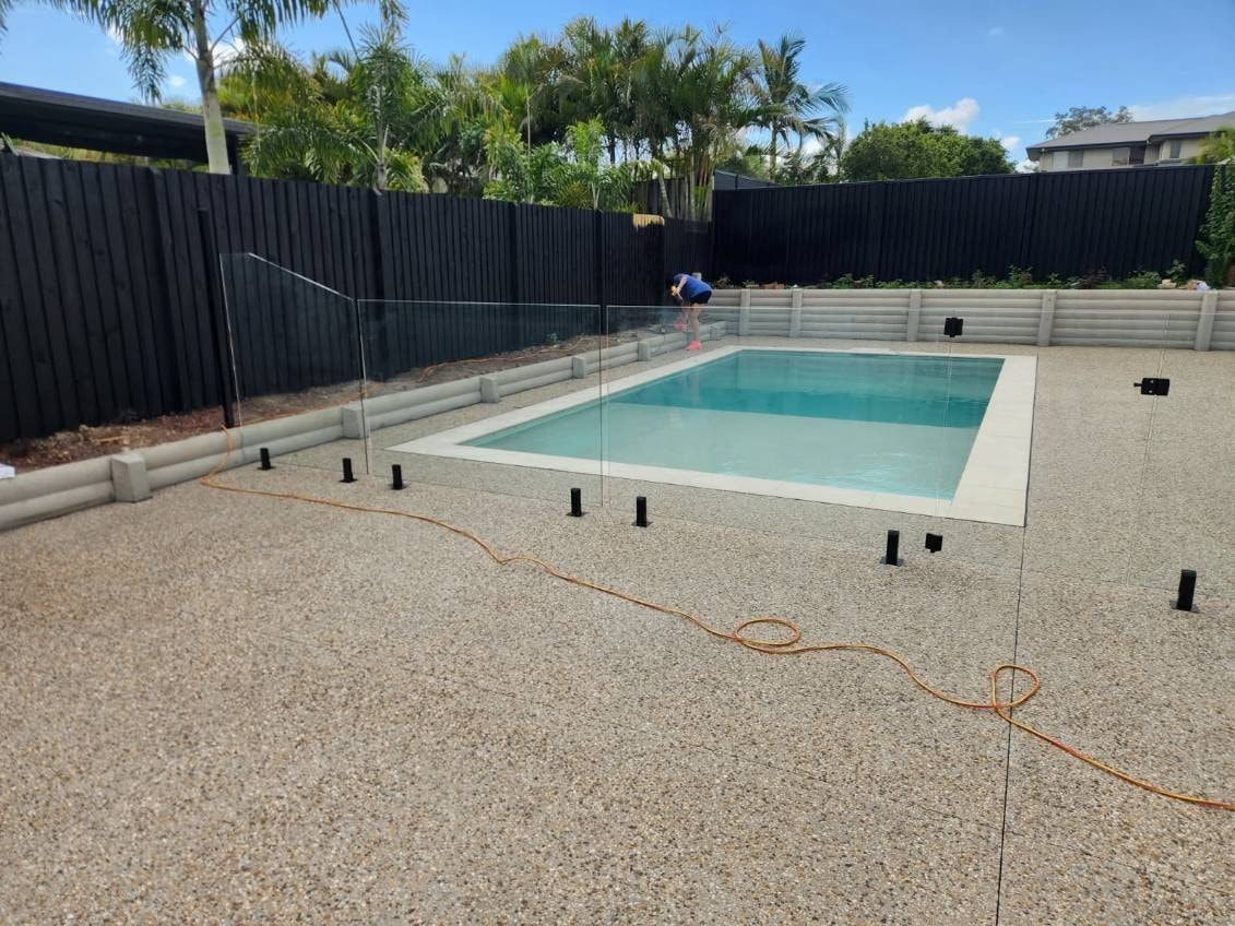 Backyard swimming pool and glass fencing